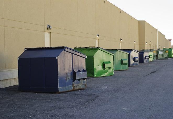 a construction worker moves construction materials near a dumpster in Cromwell IN